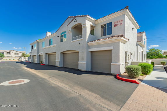 Front view of a multi-story building with attached garages.