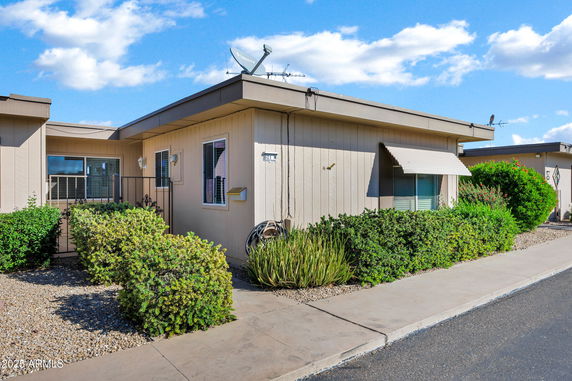 Front view of a single-story house with a satellite dish on the roof.