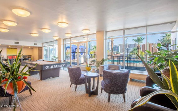 Indoor recreation area with seating and pool table.
