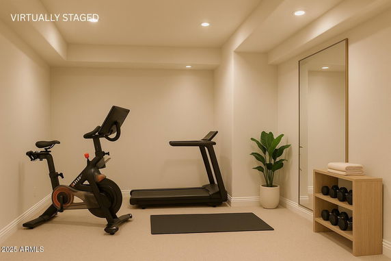 Home gym area with exercise bike, treadmill, and weights.