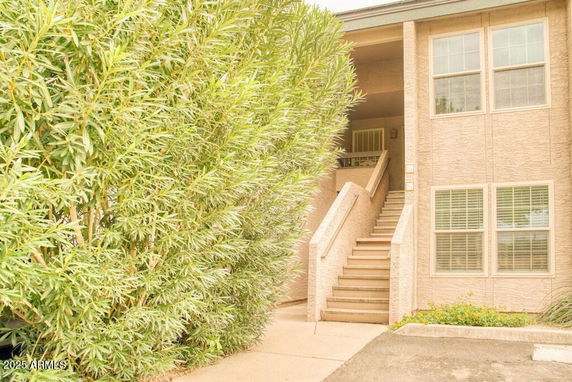 Front view of a two-story building with an outdoor staircase.
