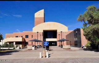 Front view of a modern building with a unique architectural design and large entrance.