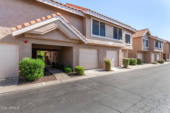 Front view of a row of townhouses with garages.