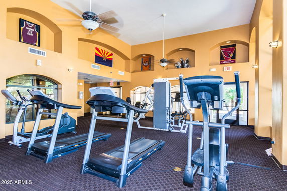 Interior view of a fitness gym area with treadmills and exercise equipment.