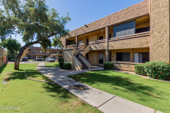 Front view of a two-story apartment building with exterior staircases.