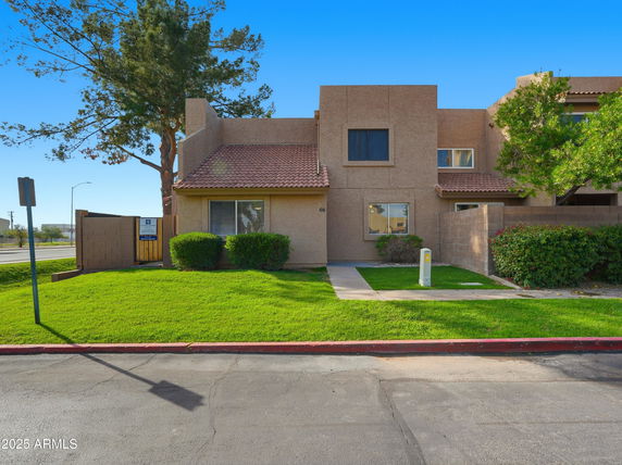 Front view of a two-story house with a tiled roof.