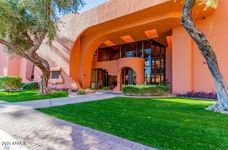 Front view of a building with large windows and an arched entrance.