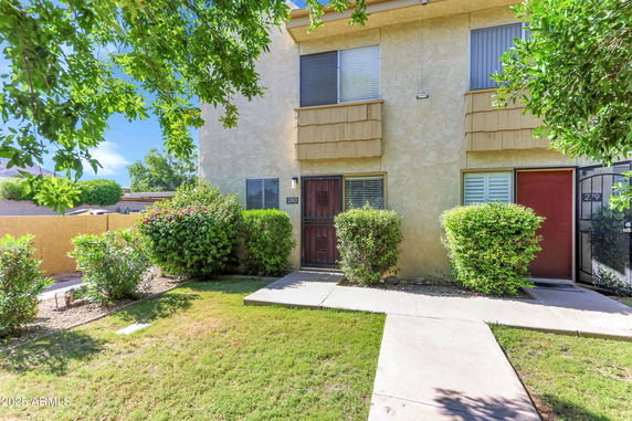 Front view of a two-story house with a gated entrance.