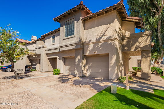 Front view of a two-story house with garage and driveway.