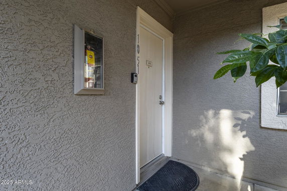 Entrance of a building with a numbered door and textured walls.