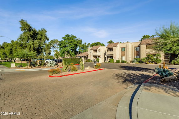 Front view of a two-story apartment building with a paved driveway.