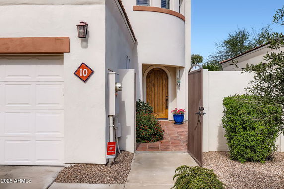 Front view of a house with a wooden door and a garage.