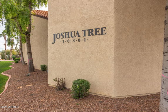 Front view of a building with 'Joshua Tree' sign and address 10301.
