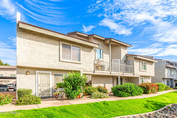Front view of a multi-story residential building with balconies.
