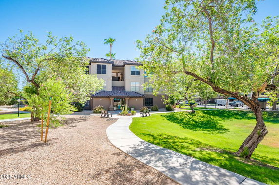 Front view of a multi-story building with a sloped roof.
