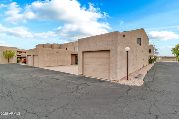 Front view of a two-story building with attached garages.