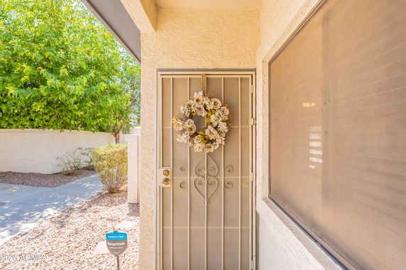 Front entrance of a house with a decorative wreath on the door.