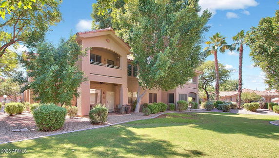 Front view of a two-story house with an open porch and a balcony.