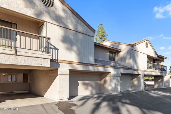 Front view of a two-story building with multiple garage doors.