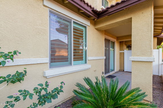 Front view of a house with a stone exterior and large windows.