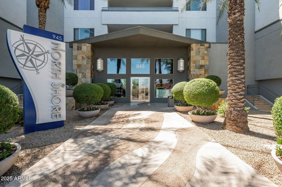 Front view of a building entrance with 'North Shore' signage and landscaped walkway.