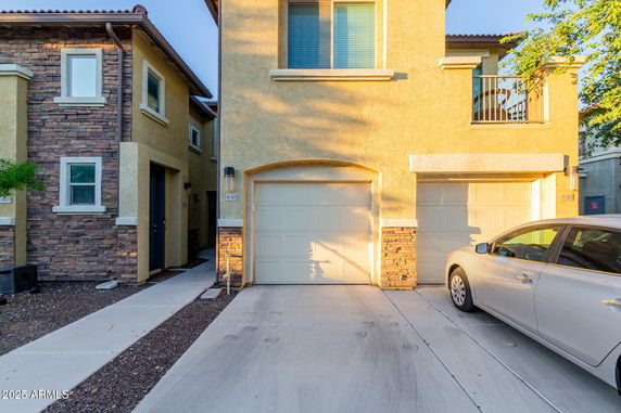 Front view of a two-story house with attached garage and brick accents.