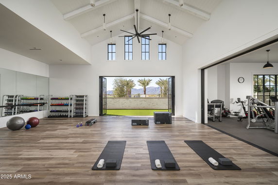 Interior of a gym area with yoga mats, exercise balls, and fitness equipment.