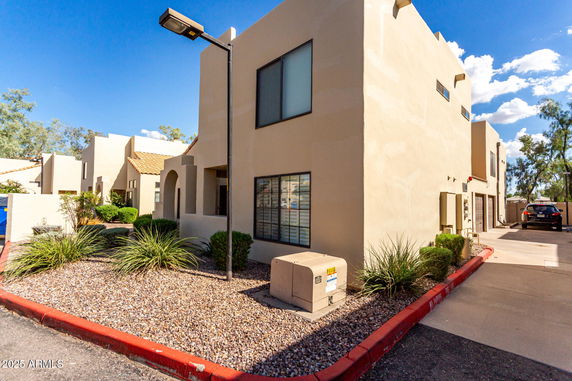 Front view of a two-story building with stucco walls and flat roof.