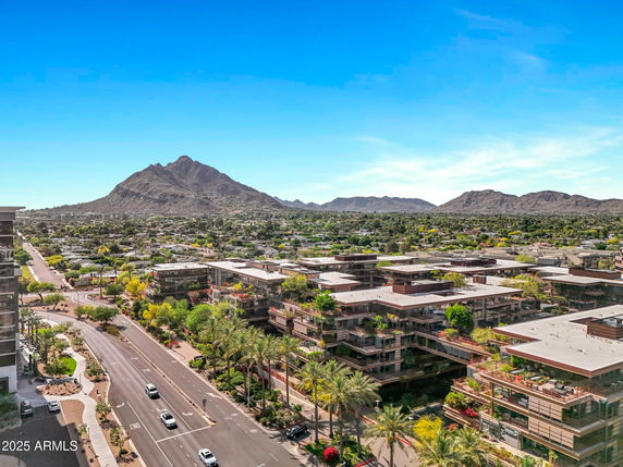 Wide-angle view of buildings with a mountain backdrop.