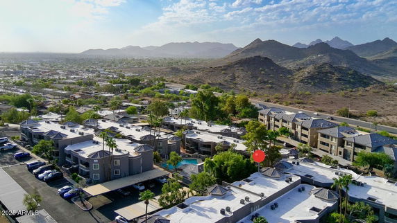 Wide-angle view of residential buildings with surrounding landscape.