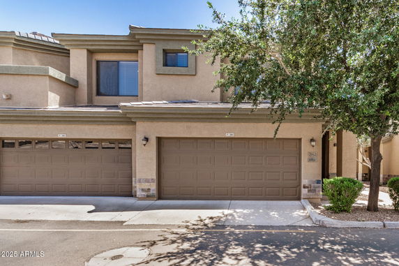 Front view of a two-story house with double garage doors.