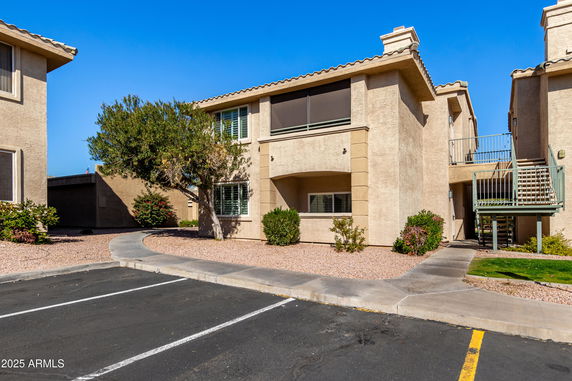Front view of a two-story apartment building with exterior stairs.