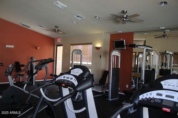 Indoor gym area with exercise equipment such as treadmills and weight machines.