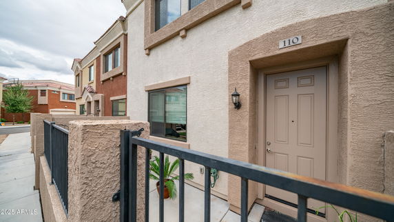 Front view of a townhouse with beige and brown exterior.