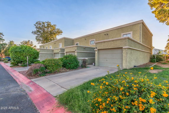 Front view of a two-story house with a garage and driveway.