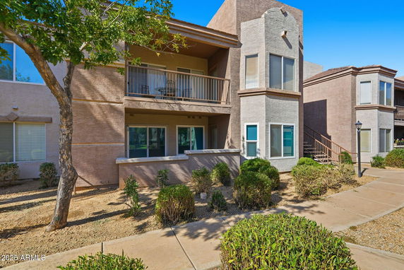 Front view of a multi-story residential building with balconies.
