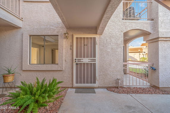 Front view of a building entrance with a door and window.