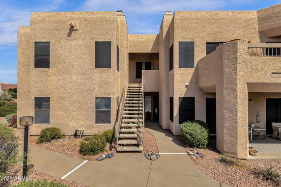 Front view of a multi-level building with central staircase entrance.