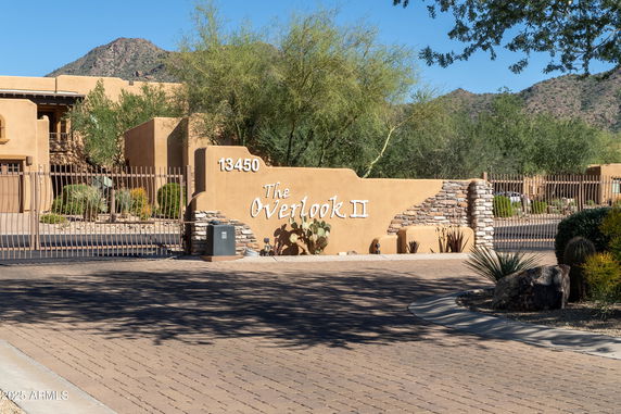 Front view of a building entrance with gated access and sign reading 'The Overlook II'.