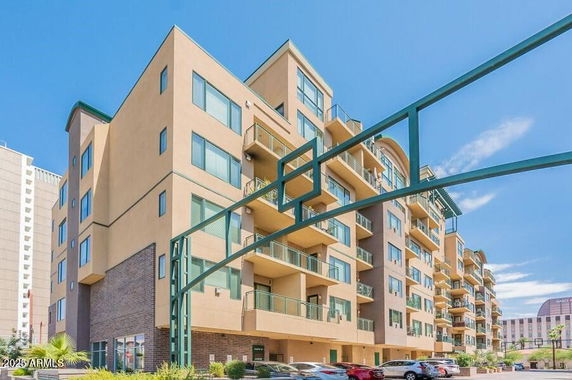 Front view of a multi-story apartment building with balconies.