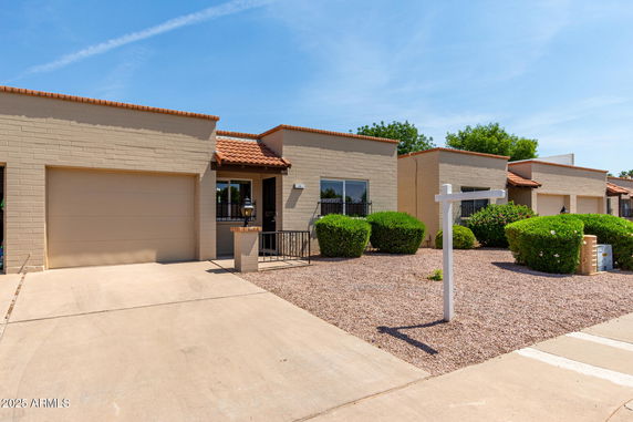 Front view of a house with a single garage and a small porch area.