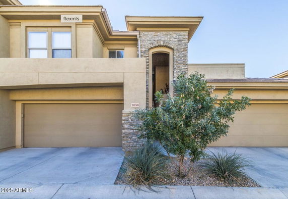 Front view of a two-story house with a double garage.