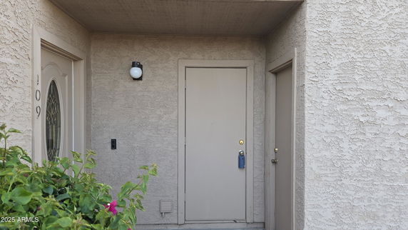 Front view of a house entrance with multiple doors.