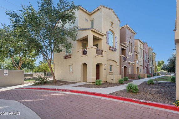 Front view of a multi-story residential building with balconies.
