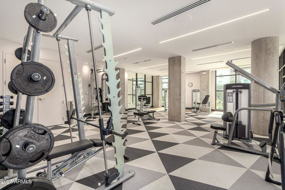 Interior view of a modern gym with various exercise equipment.