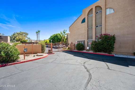 Front view of a multi-story building with gated entrance