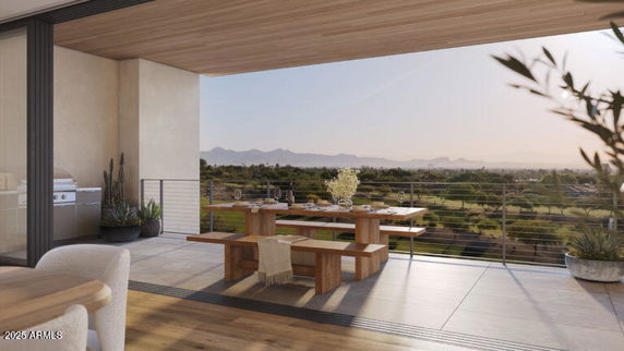 Outdoor terrace with dining table offering a panoramic view of the surrounding landscape.