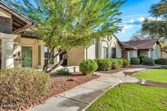 Front view of a single-story house with a landscaped yard.