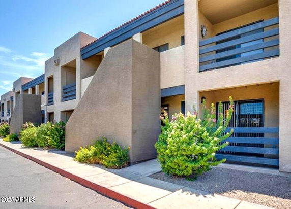 Front view of a multi-story apartment building with balconies.