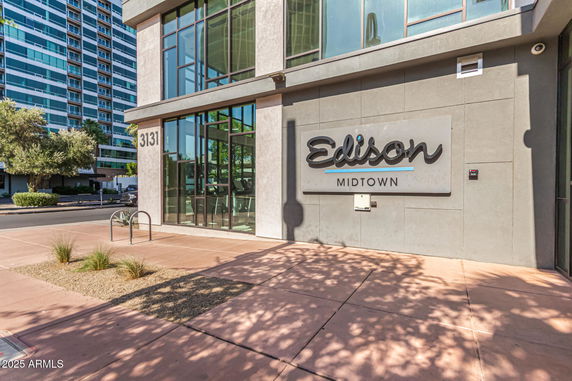 Front view of a modern building with large windows and signage reading 'Edison Midtown'.